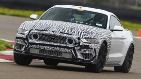 White-and-black camouflaged 2021 Ford Mustang Mach 1 testing on the racetrack