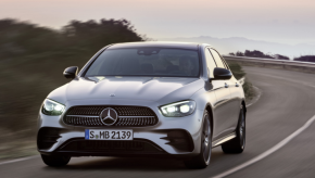 a new E-class sedan driving on the road