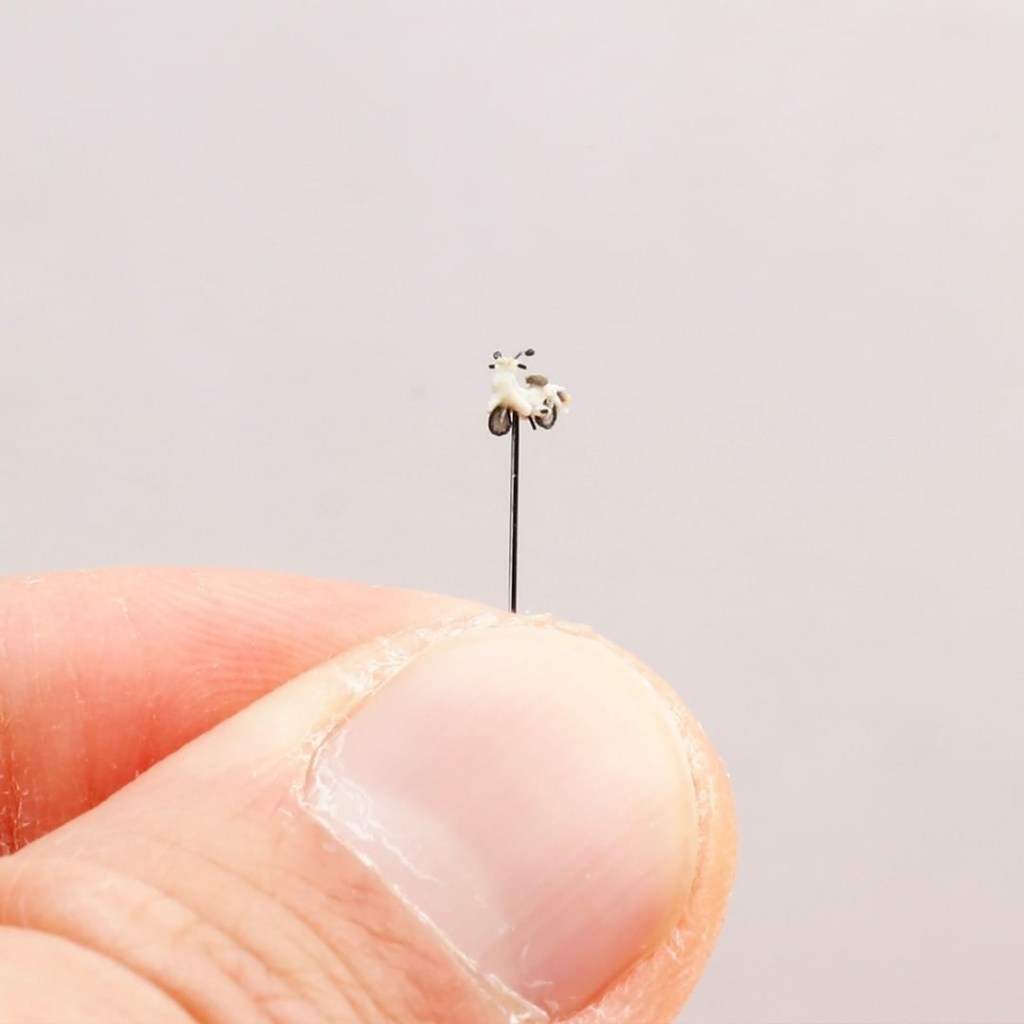 a clay Honda Motorcycle, tinier than a fingernail