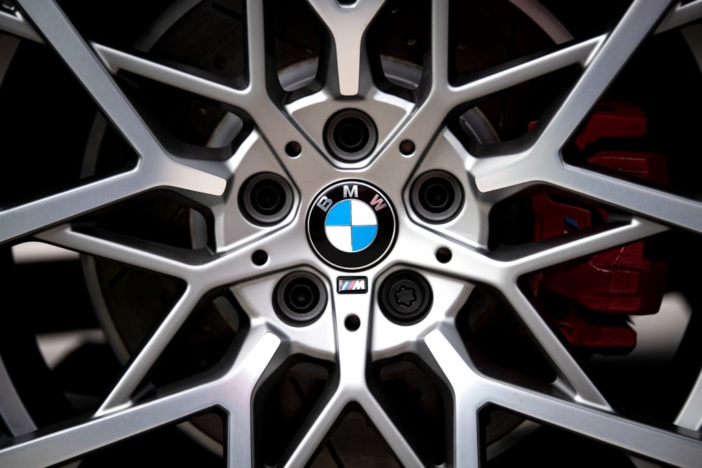 The logo of the Munich car manufacturer BMW can be seen on the rims of a car