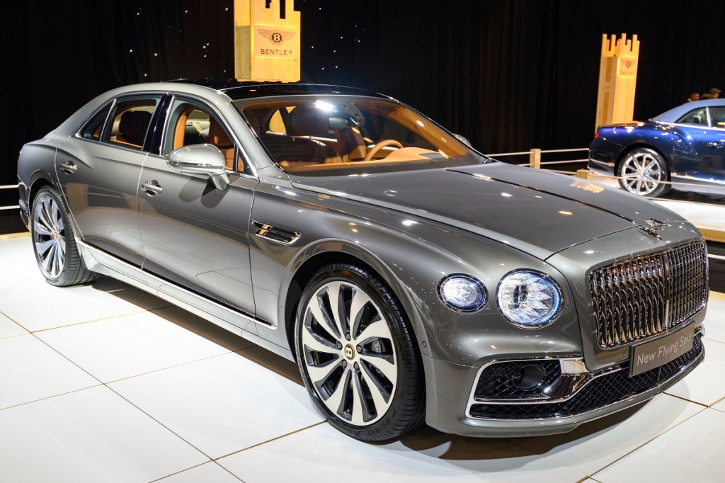A charcoal colored Bentley Flying Spur sits on display at a car show