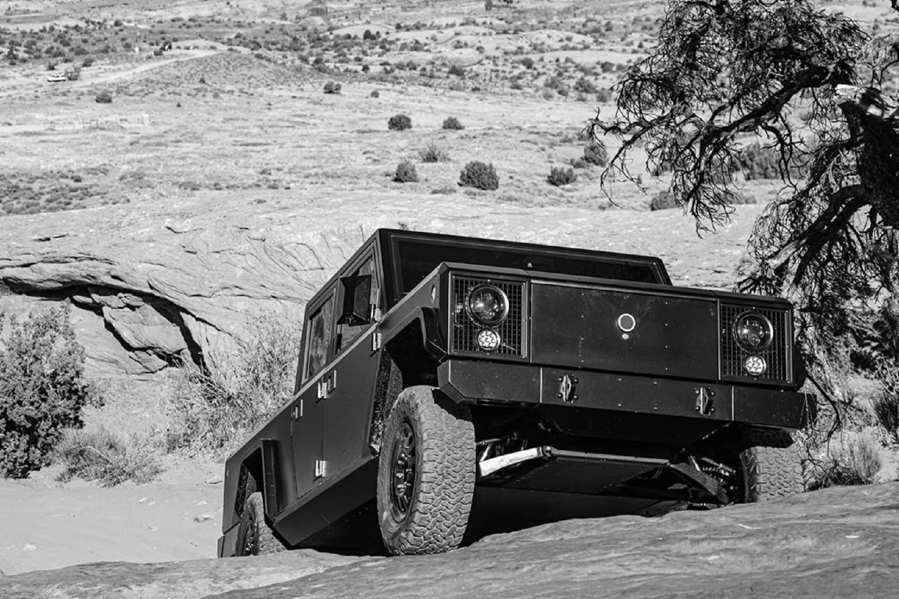 Bollinger B2 electric truck climbing up a rocky hill