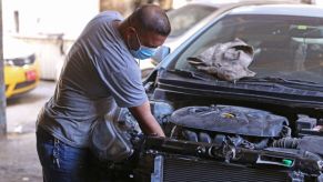 A mechanic does work on a car