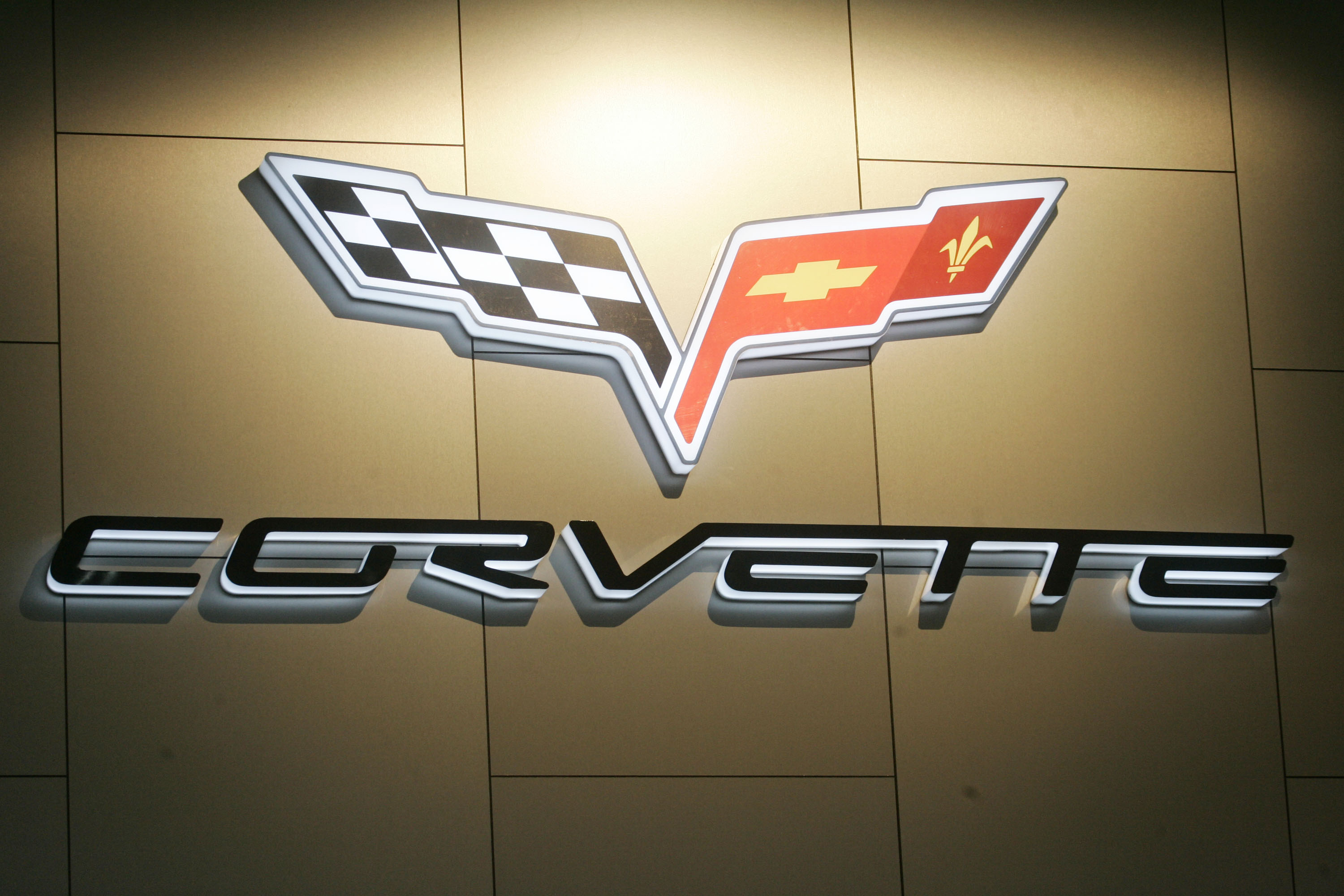 The Corvette logo was into a wall hanging and is spotlighted from above