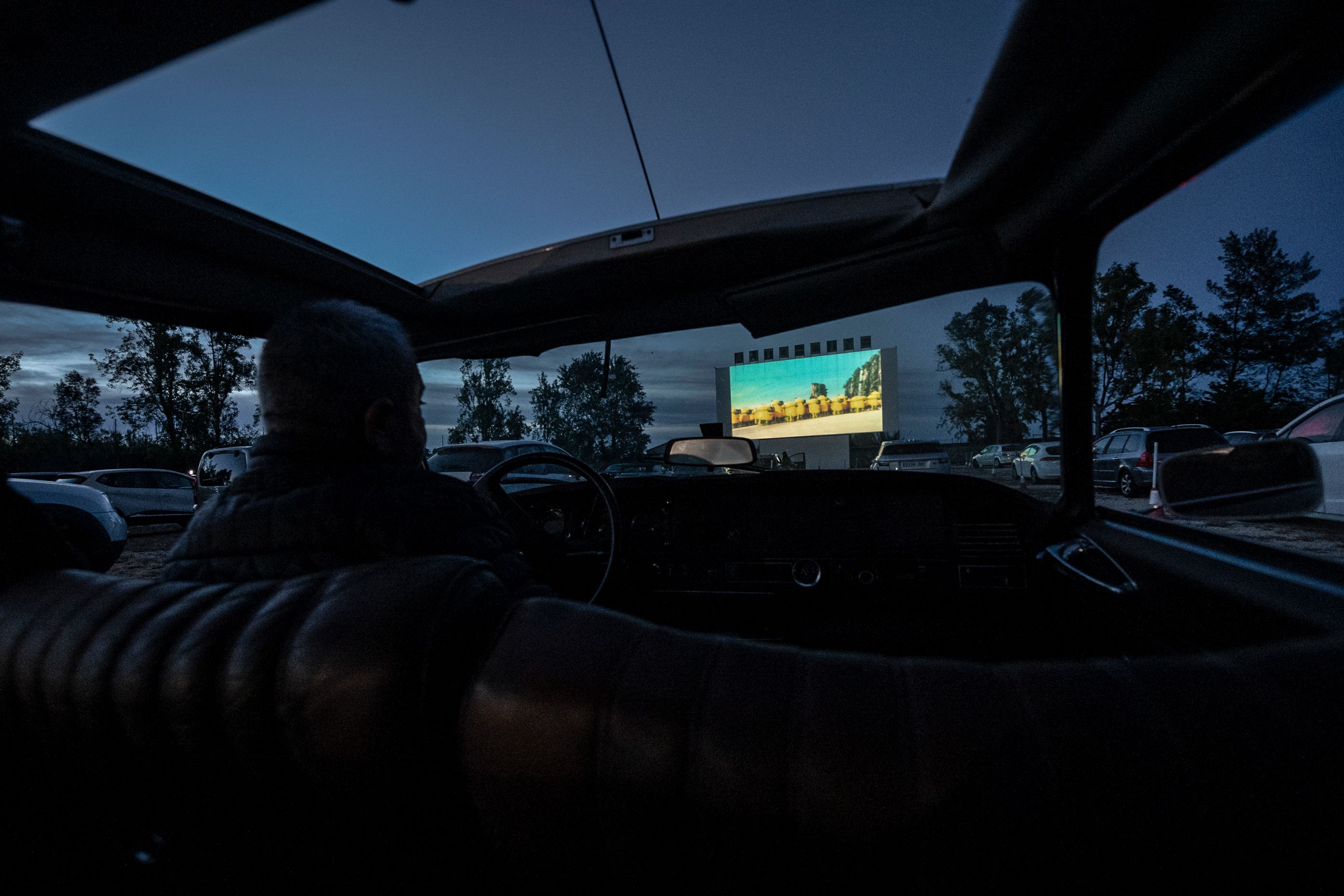 View of the drive-in screen from inside a vehicle at night time