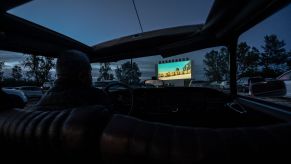 View of the drive-in screen from inside a vehicle at night time