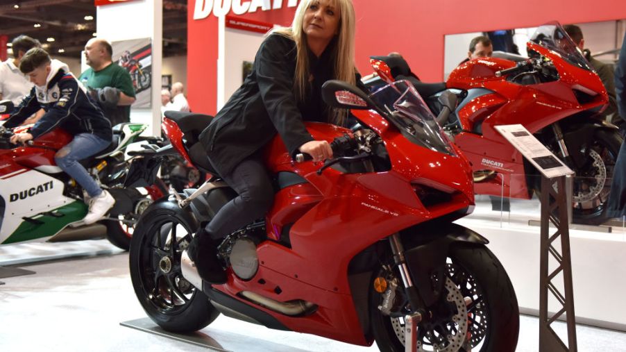A woman sitting on a display Ducati Panigale V2