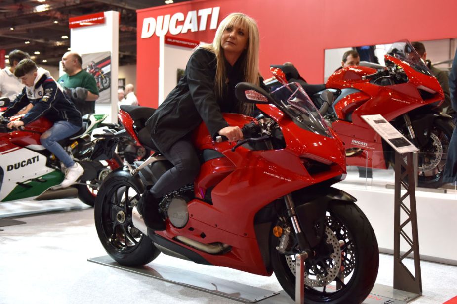 A woman sitting on a display Ducati Panigale V2