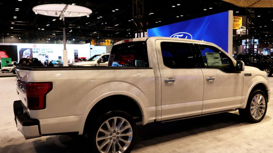 A white Ford F-150 on display at an auto show