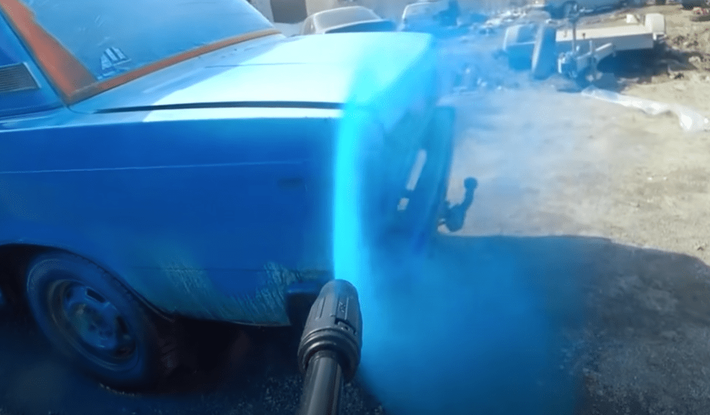 Lada being painted with pressure washer