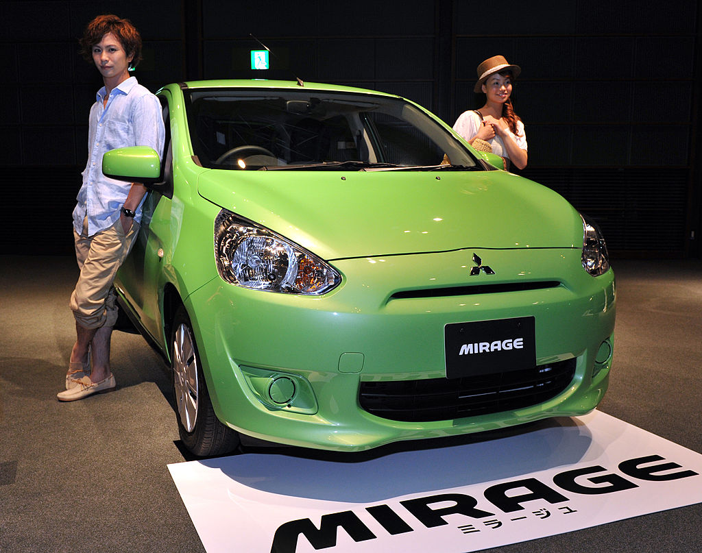 A green Mitsubishi Mirage on display at an auto show