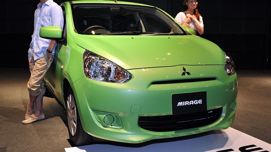 A green Mitsubishi Mirage on display at an auto show