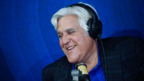 Jay Leno doing a radio interview and smiling