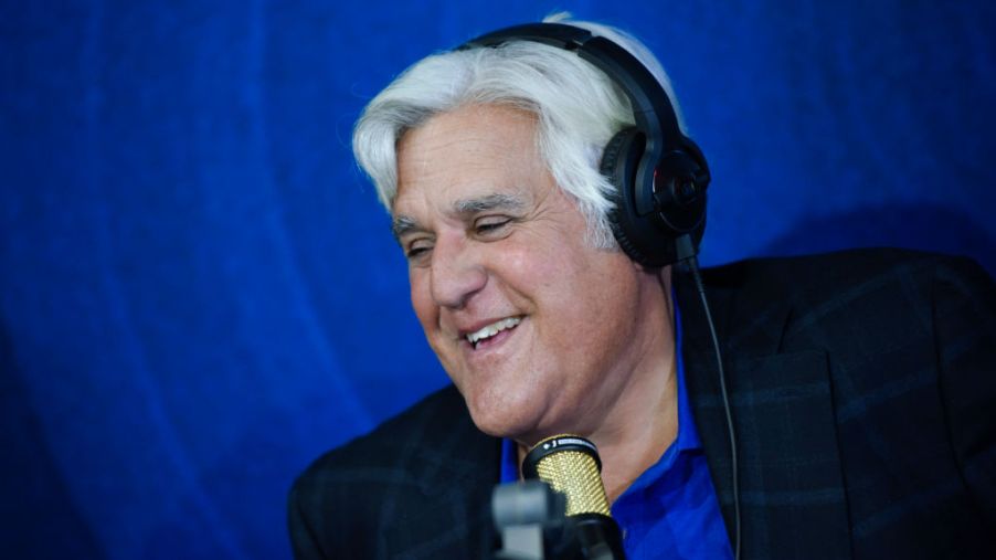 Jay Leno doing a radio interview and smiling