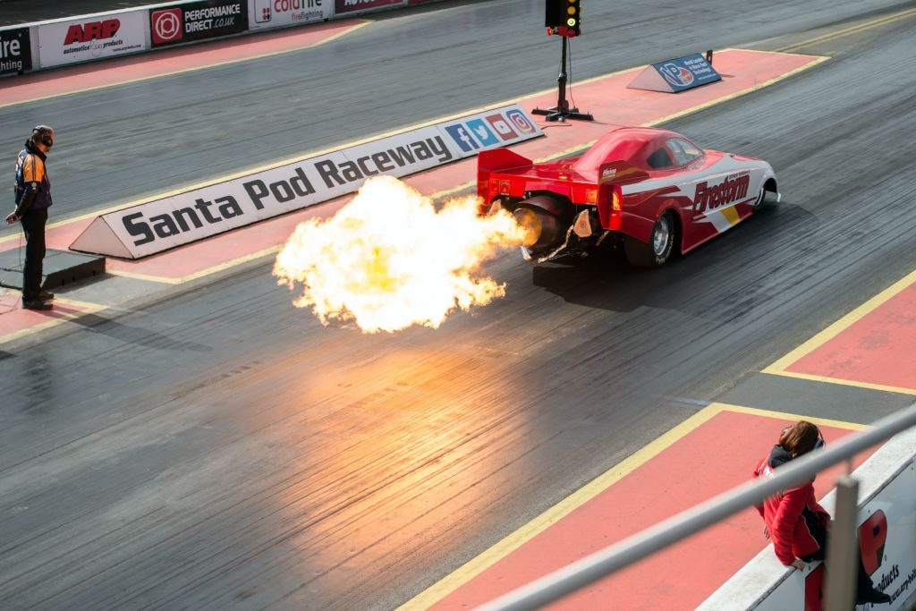A jet-powered car taking off in a drag race