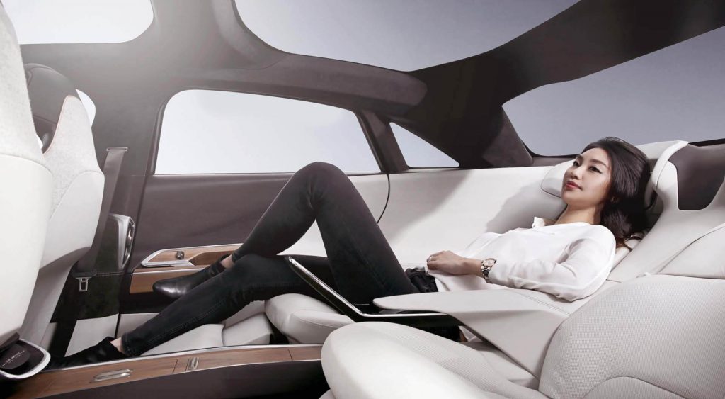 woman reclining in the rear seats of the Lucid Air concept vehicle