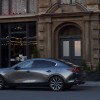 a gray Mazda 3 parked in the city