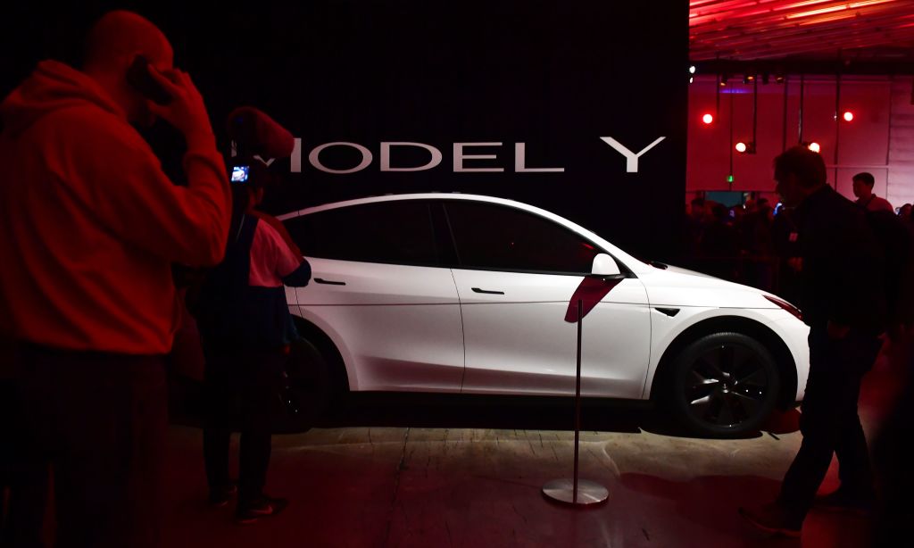 People view a model of the new Tesla Model Y unveiled earlier in Hawthorne, California