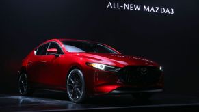 A Mazda3 being debuted at an auto show
