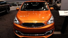 An orange Mitsubishi Mirage on display at an auto show