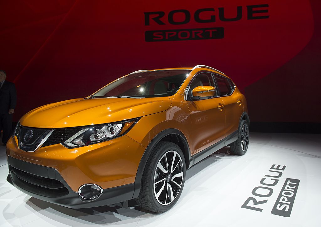 An orange Nissan Rogue Sport on display at an auto show