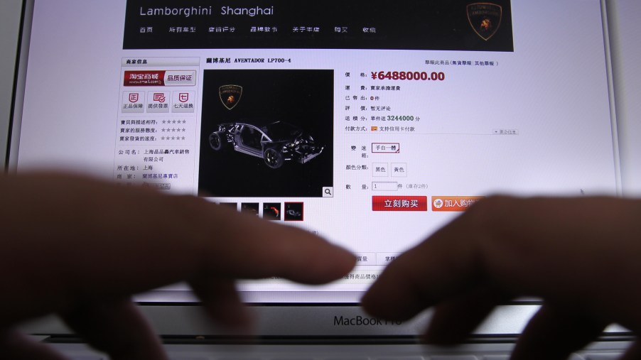 A computer screen shows a Lamborghini at an online auction website