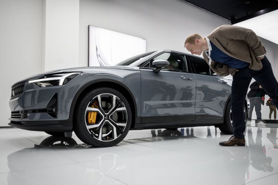 A men checking out a new Polestar 2 at an auto show