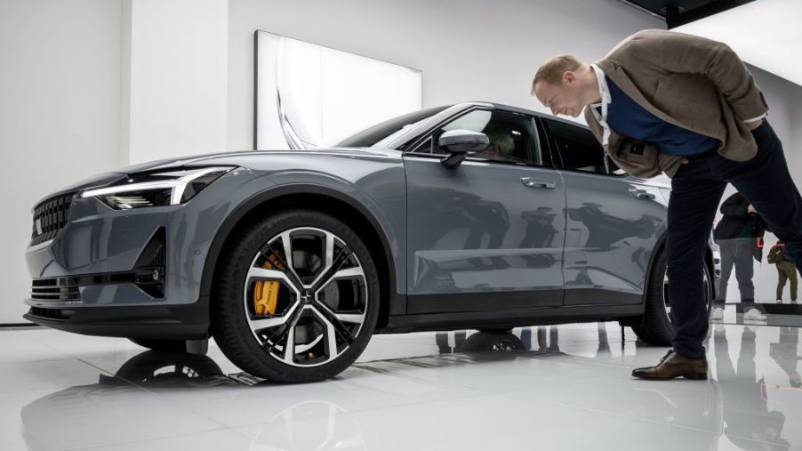 A men checking out a new Polestar 2 at an auto show