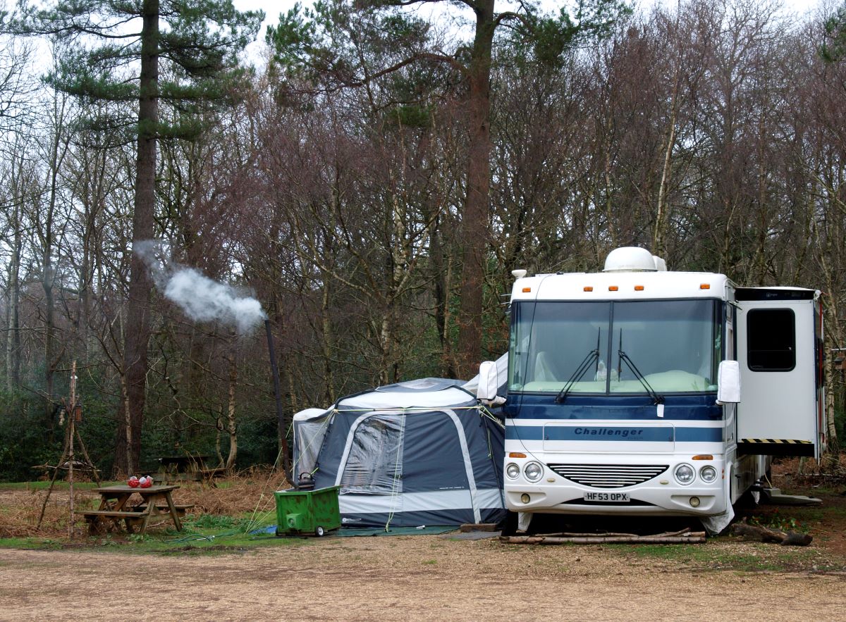 A campsite set up next to an RV