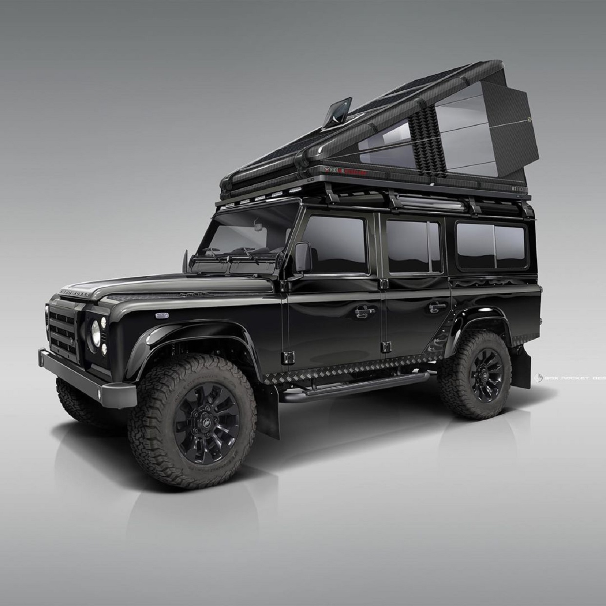 Black carbon-fiber RTC 110 roof tent mounted on black classic Land Rover Defender 110