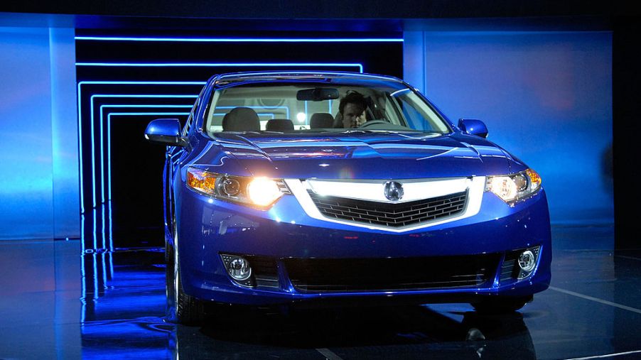 The 2009 Acura TSX , sporting the company's new grille design, is driven through a tunnel during its debut at the 2008 New York International Auto Show