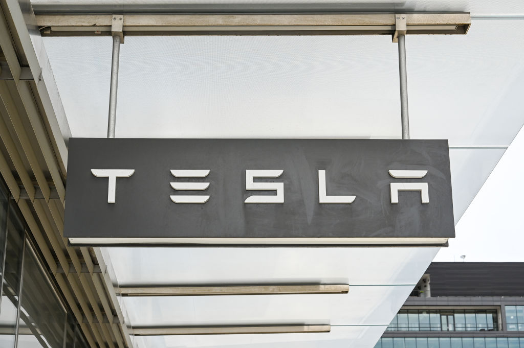 A Tesla sign seen outside a storefront