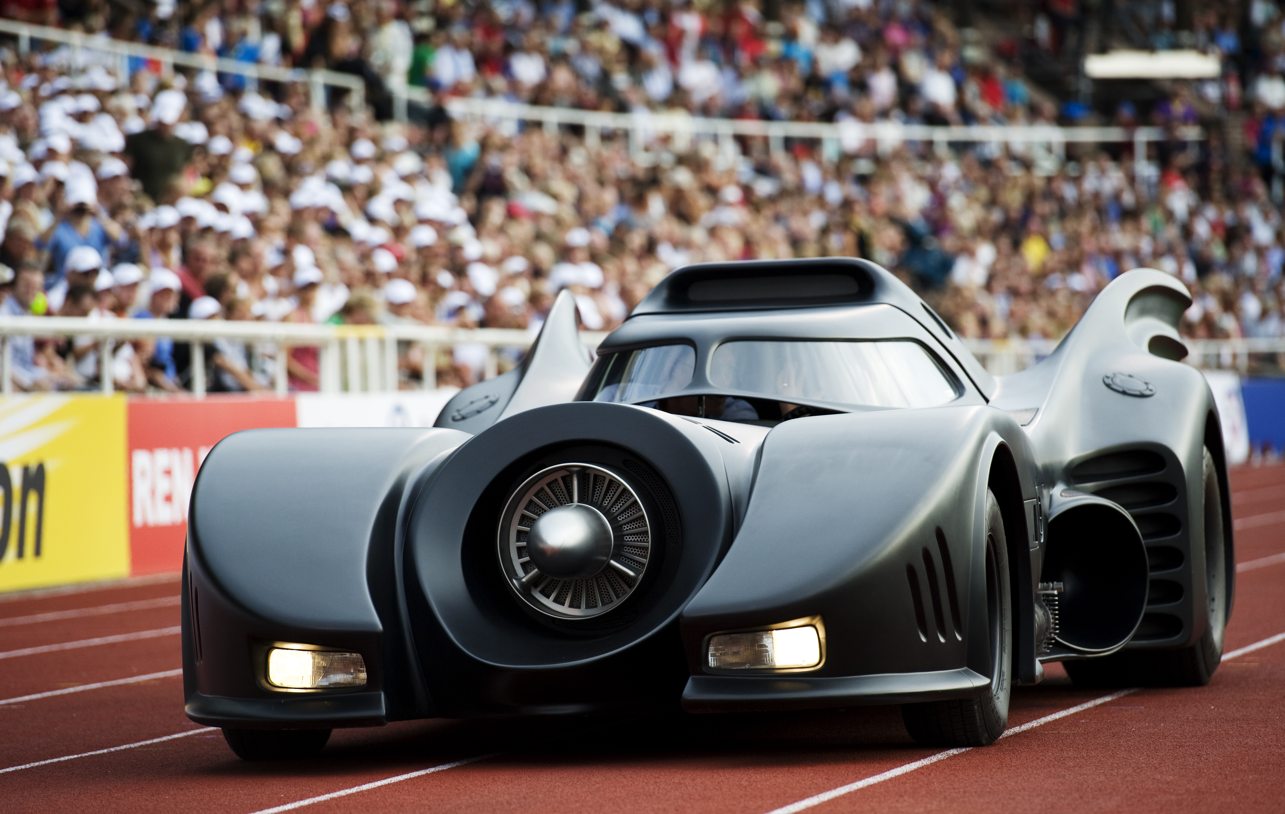 A Batmobile replica enters a stadium