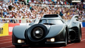A Batmobile replica enters a stadium
