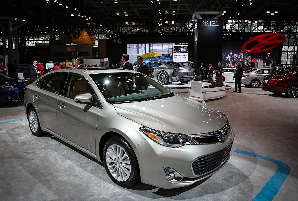The Toyota Avalon Hybrid on display at an auto show