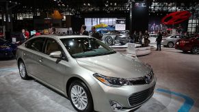 The Toyota Avalon Hybrid on display at an auto show