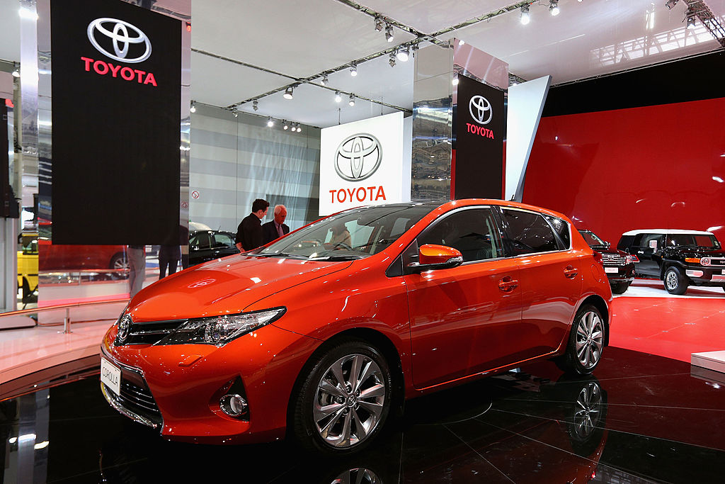A red Toyota Corolla on display at an auto show