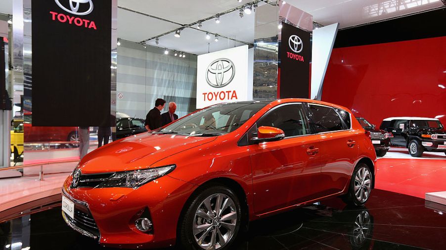 A red Toyota Corolla on display at an auto show