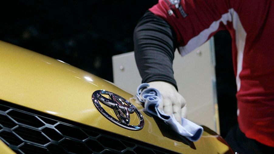 A worker polishes the hood of a Toyota Matrix during the first Media preview day at the Chicago Auto Show