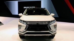 A white Mitsubishi Eclipse Cross on display at an auto show