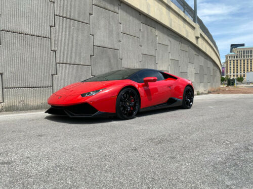World's highest mileage Lamborghini Huracan in red beside freeway