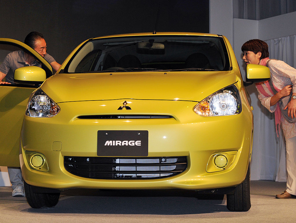 A yellow Mitsubishi Mirage on display