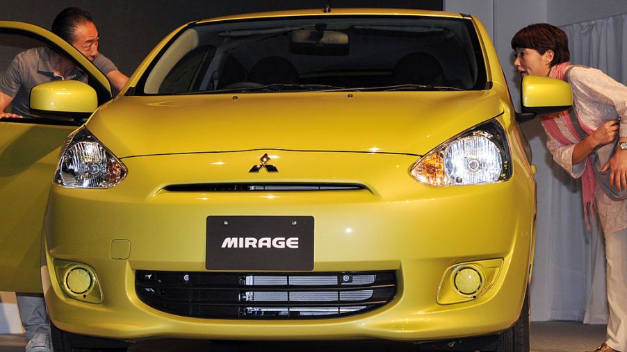 A yellow Mitsubishi Mirage on display
