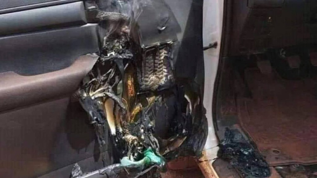 A door panel melted and smoking from fire