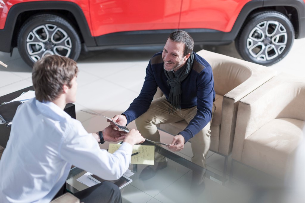 A car salesperson talking to a client 