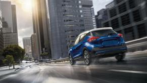 a blue Nissan Kicks navigating city streets