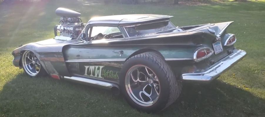 A custom El Camino sits in the grass