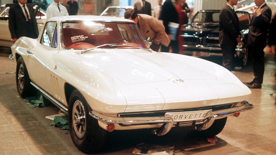 A white Corvette at a car show display