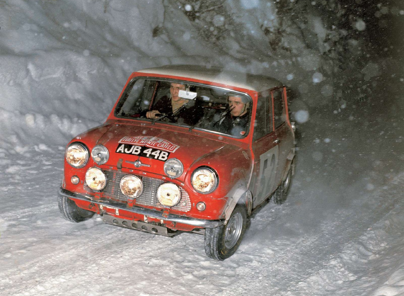 Red 1965 Mini Cooper S racing in the snow at Monte Carlo