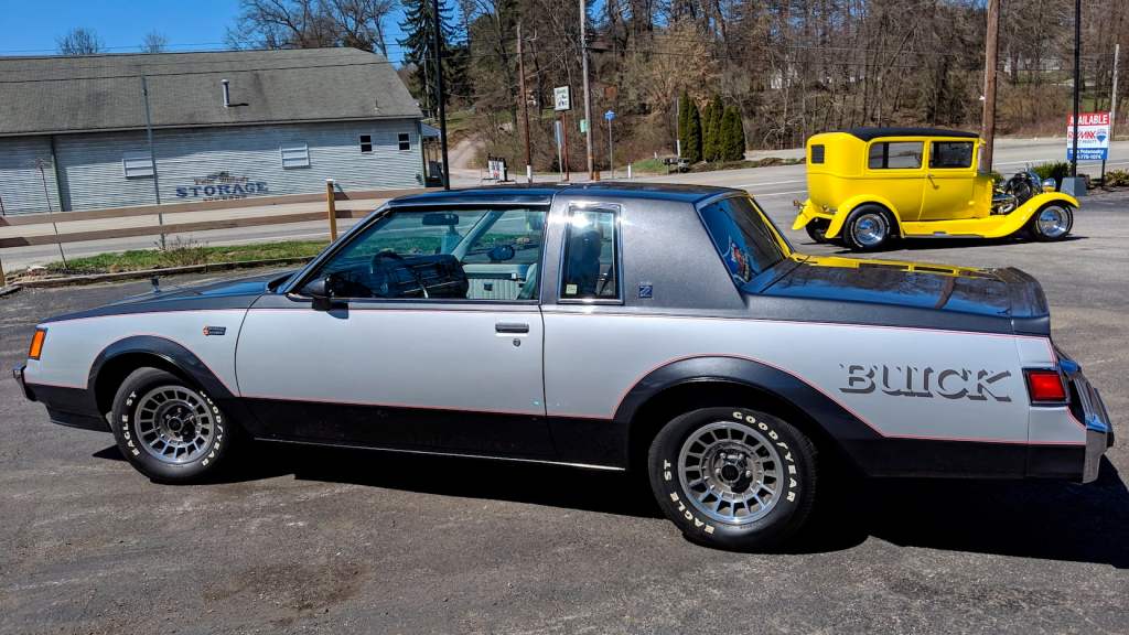 A silver and charcoal two-tone 1982 Buick Grand National in a parking lot. 